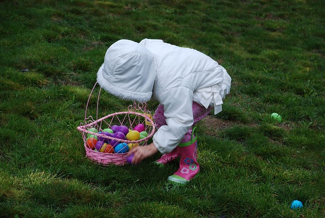 Child searching for eggs with basket in hand