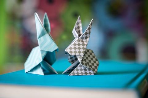 Bunny origami sitting on top of blue covered book