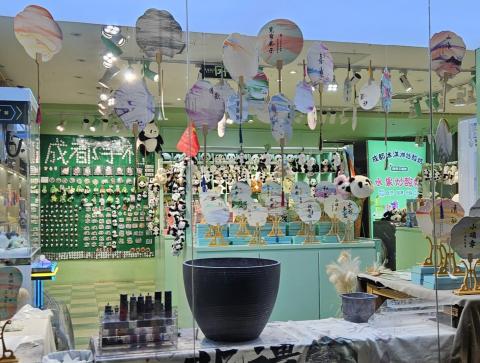 Marble-dyed fans hanging over workstation with dyes & water