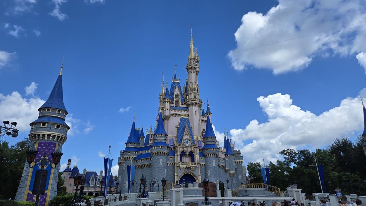 Clouds in a blue sky with Cinderella's castle in the center